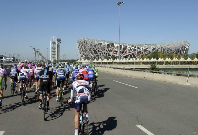 The peloton rides past the Bird's Nest stadium on the final day of the Tour of Beijing.