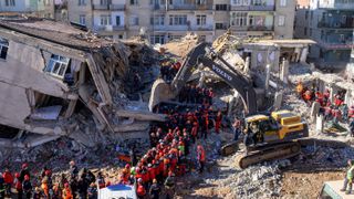 Rescue workers remove corpses from the rubble of a building after an earthquake in Elazig, eastern Turkey, on Jan. 26, 2020.