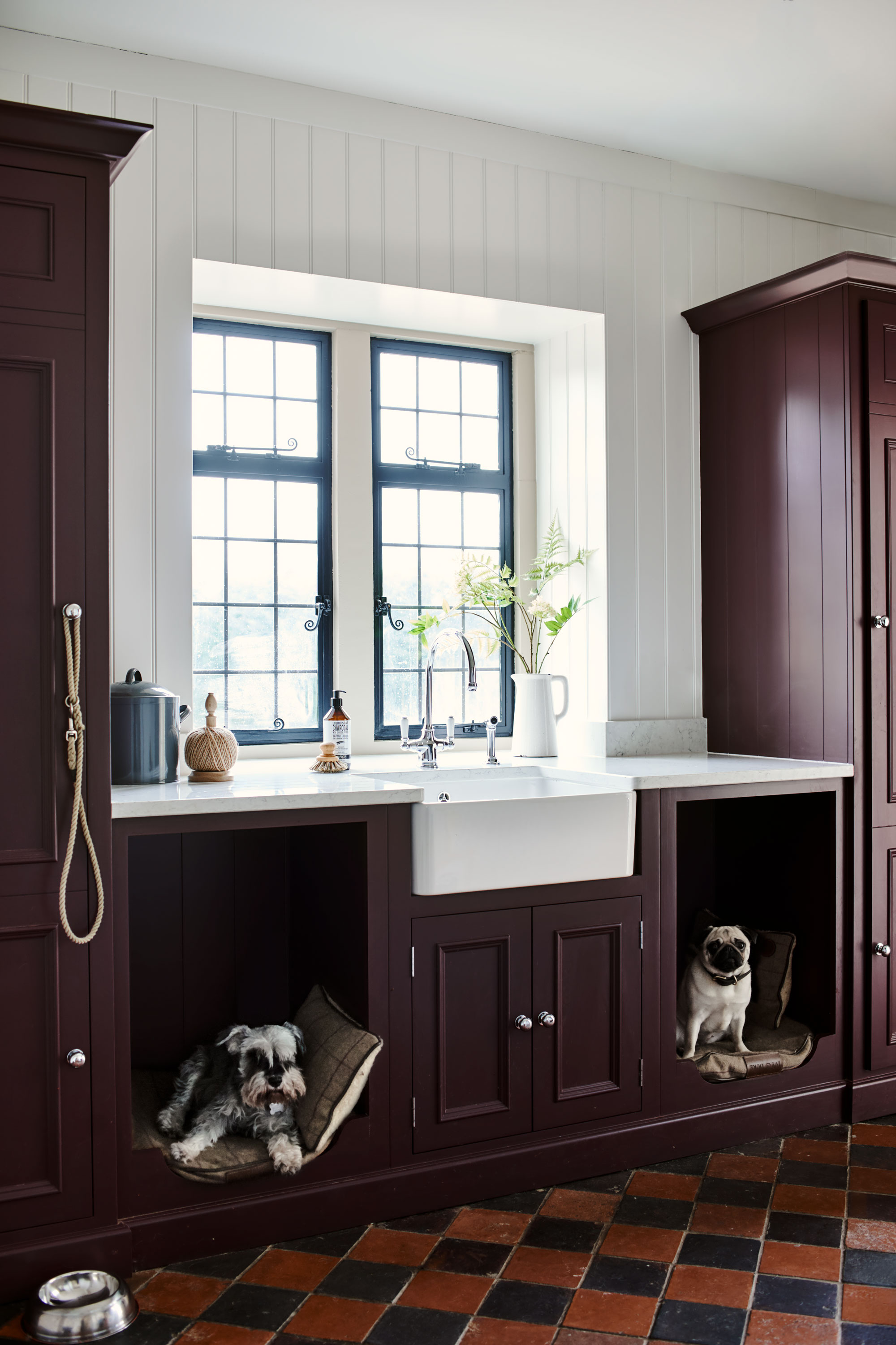 a laundry room with dog beds built in