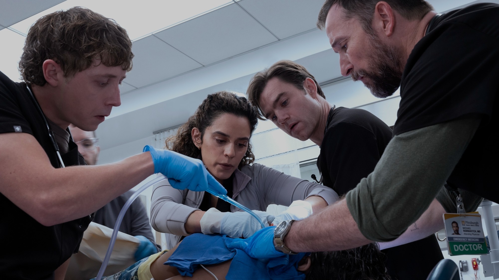 Gerran Howell, Sepideh Moafi, Patrick Ball and Noah Wyle in The Pitt, working on a patient.
