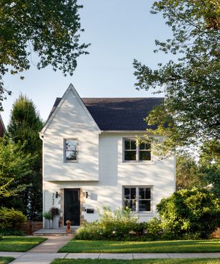 house exterior with gable and white render