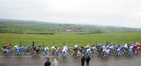 The peloton speeds past the sodden French countryside.