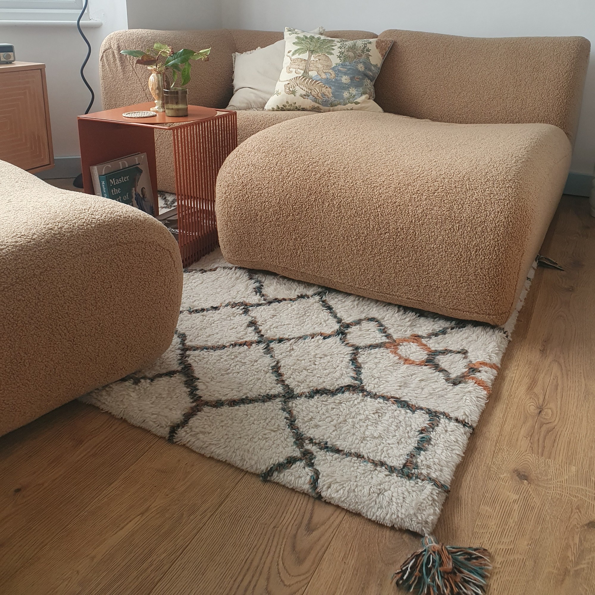 The living area in my studio flat with my modular King Living 1977 sofa on top of an Origins Berber-style wool rug