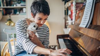Lady playing piano with chihuahua