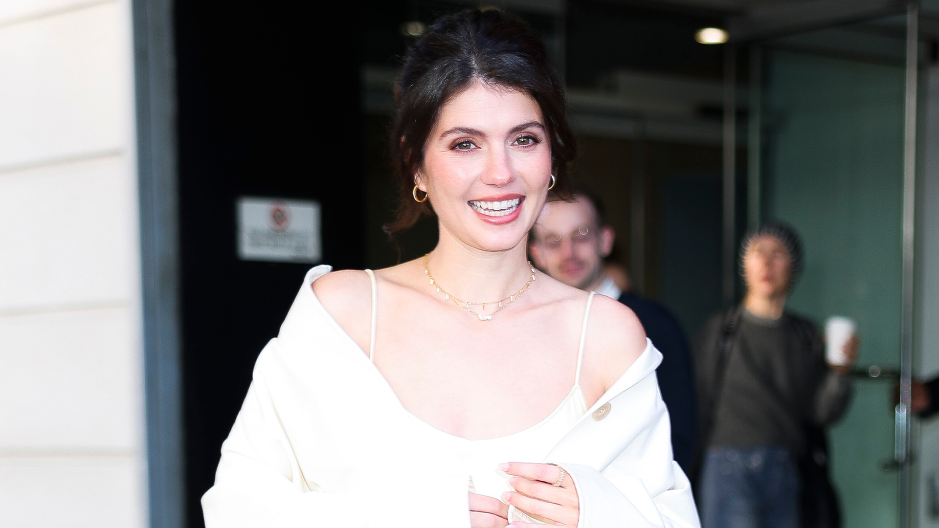 Emily Bader wore a butter yellow satin slip dress on the People We Meet On Vacation press tour