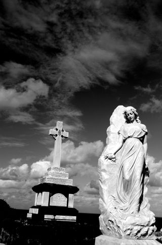 Black and white photo of carved gravestones