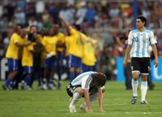 Argentina pair Gabriel Heinze and Juan Roman Riquelme look dejected as Brazil celebrate victory in the 2007 Copa America final.