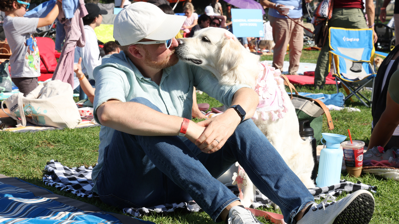 A dog kissing its human at the PAW Patrol: The Mighty Movie screening.