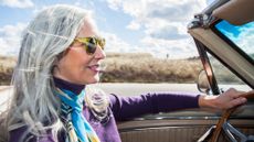 Woman in a car with her hair blowing in the wind