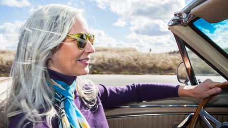 Woman in a car with her hair blowing in the wind