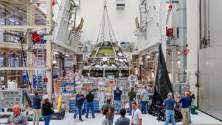 The Orion spacecraft for the moon mission Artemis 2 comes together at NASA's Kennedy Space Center in Florida. Technicians joined the European service module with the crew module at the Neil Armstrong Operations & Checkout Building Oct. 19.