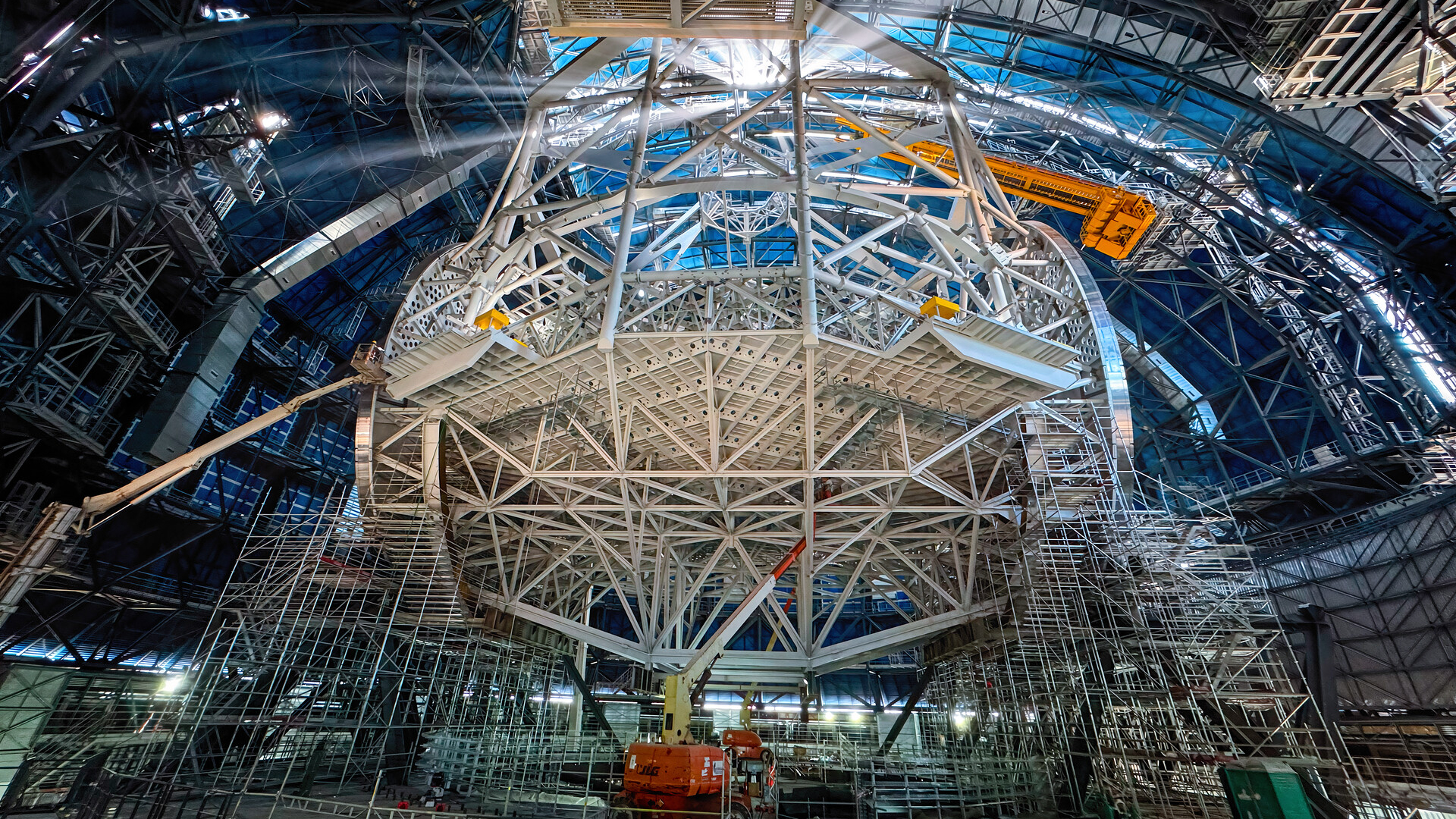 An image of a construction site with a large circular scaffolding in the middle of the scene. 