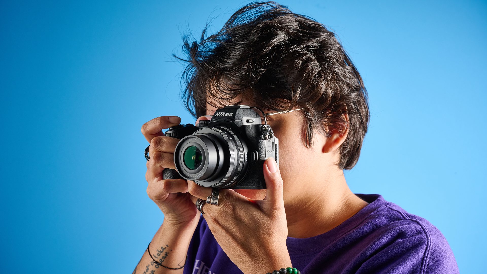 The Nikon Z50II in hand being used to shoot a photo