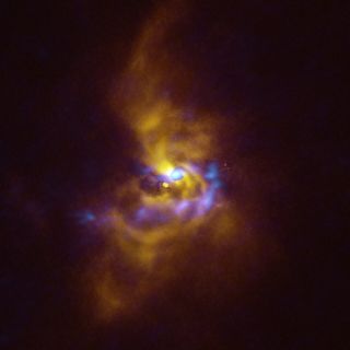 Swirls of yellow gas around a distant star contain blue clumps that could be on the verge of collapsing into planets