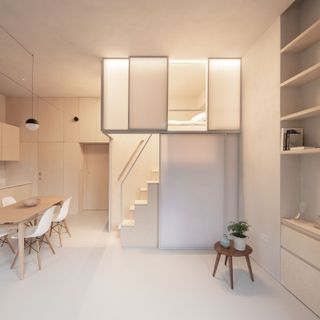 a studio apartment with a loft bed