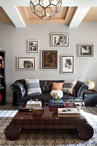 A living room with charcoal sofa and orange ceiling