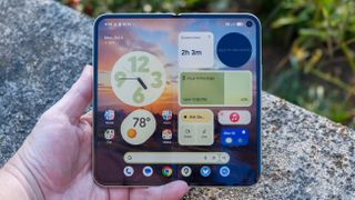 Google Pixel 10 Pro Fold in Jade green outside at a flower garden on a sunny day