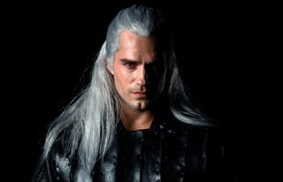 HENRY CAVILL as geralt of rivia with long white hair in a still from the witcher