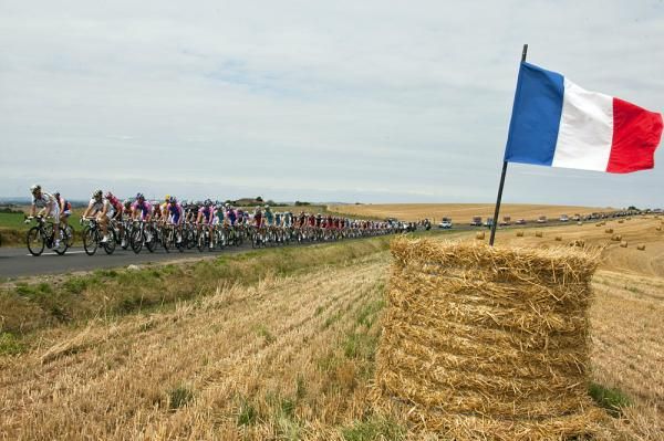 The French flag flies over the peloton.
