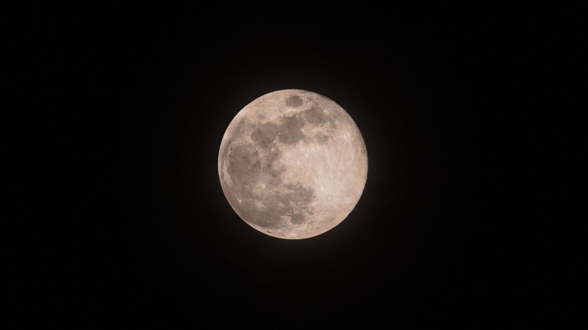 a bright full moon against a black sky