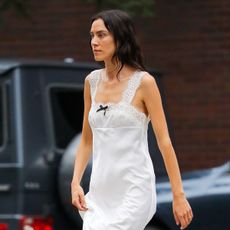 Alexa Chung wearing a white maxi dress with patent leather knee boots in NYC