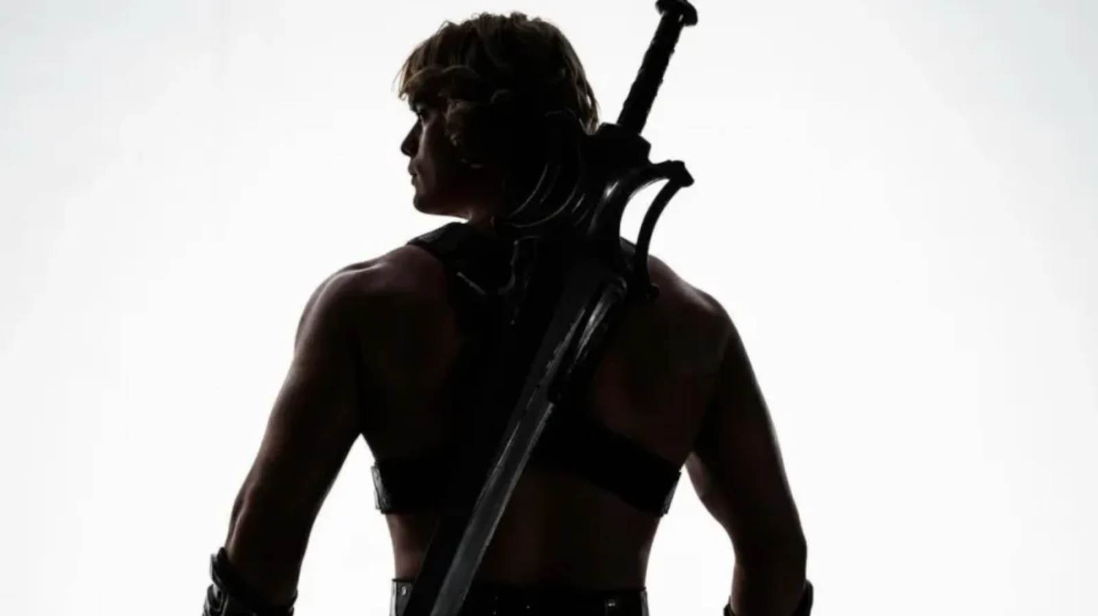Nicholas Galitzine as He-Man with his back to the camera
