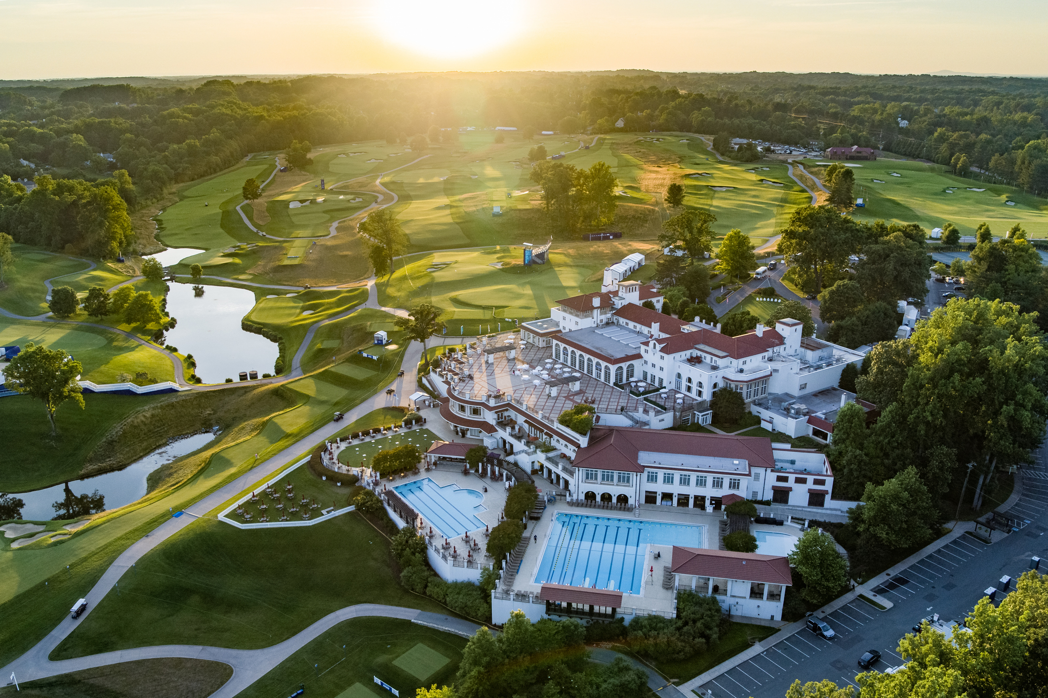 Bethesda, MD, USA - June 21, 2022: Aerial shot of the Congressional Country Club just before the LPGA Championship tournament, captured at golden hour showing the clubhouse and grounds with the sunset in the background.
