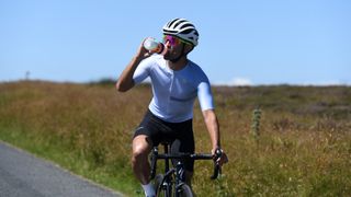 Image shows a rider cycling in hot weather.