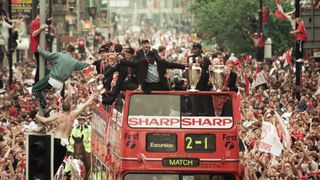 Manchester United – the stars of new Amazon MGM Studios documentary 99 – celebrate winning the treble as the jubilant team make their way through Manchester during an open top bus parade. Teddy Sheringham and Dwight Yorke on 27th May 1999