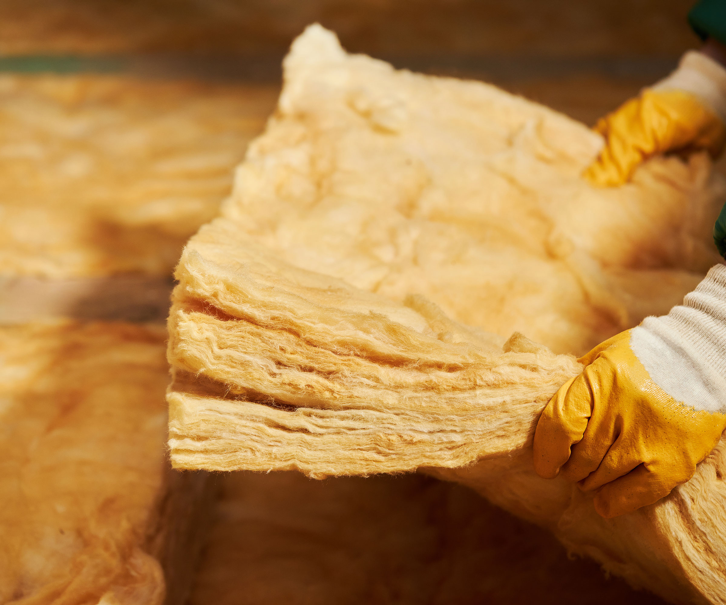 hands holding loft insulation