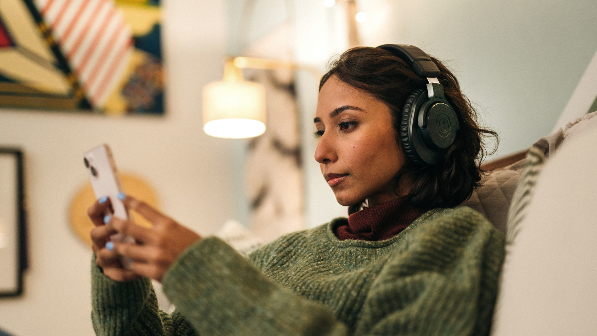 Audio-Technica ATH-M20xBT worn by a woman using her phone