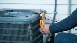 Man doing maintenance on a HVAC unit