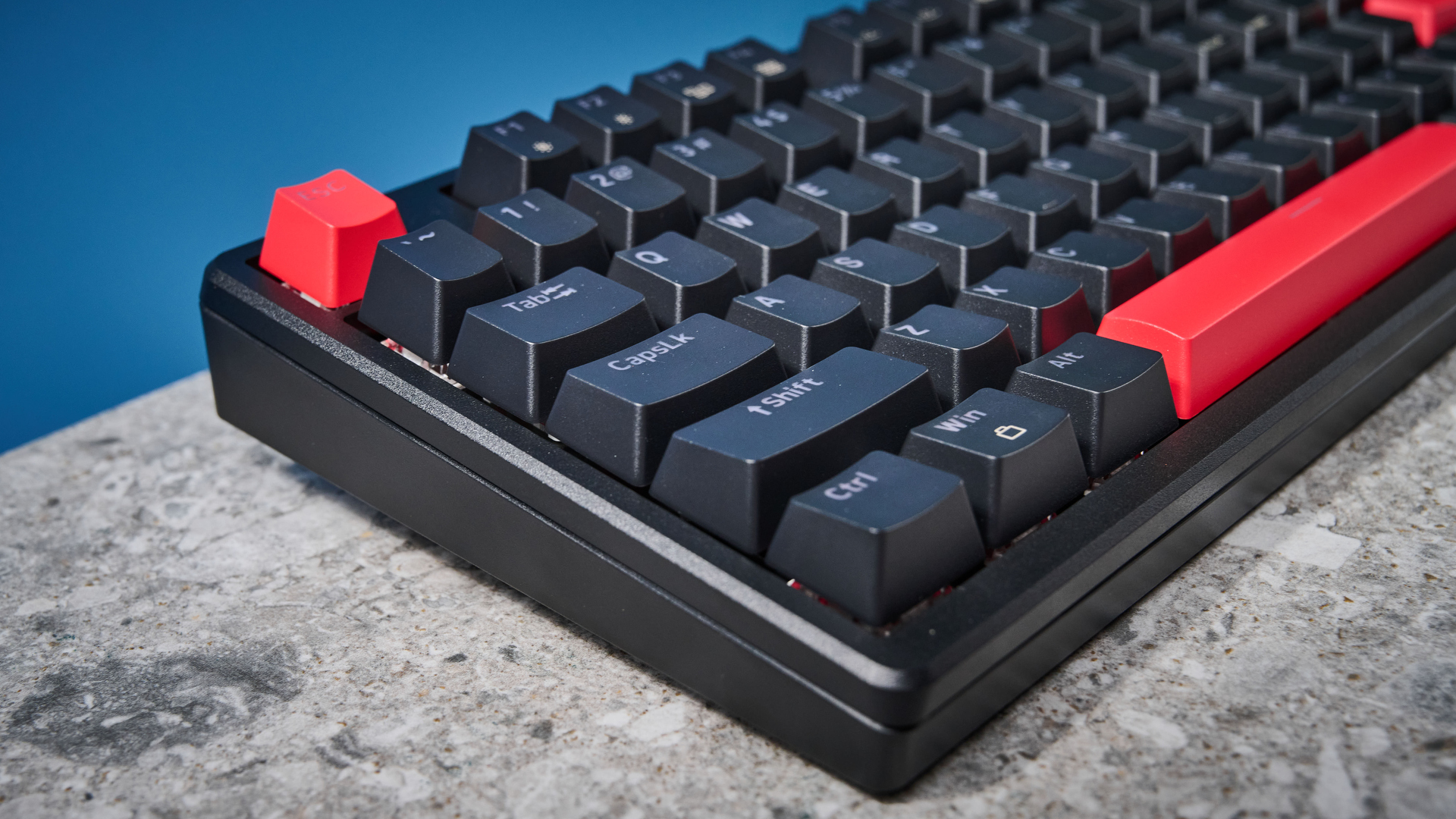 A black Lemokey X5 wired mechanical keyboard with red and black keycaps