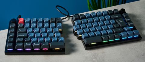 A carbon black Keychron Q11 split ergonomic keyboard