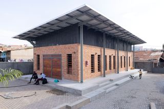 red-brick freestanding building with corrugated iron roof, Kamwokya Community Centre in Kampala, Uganda