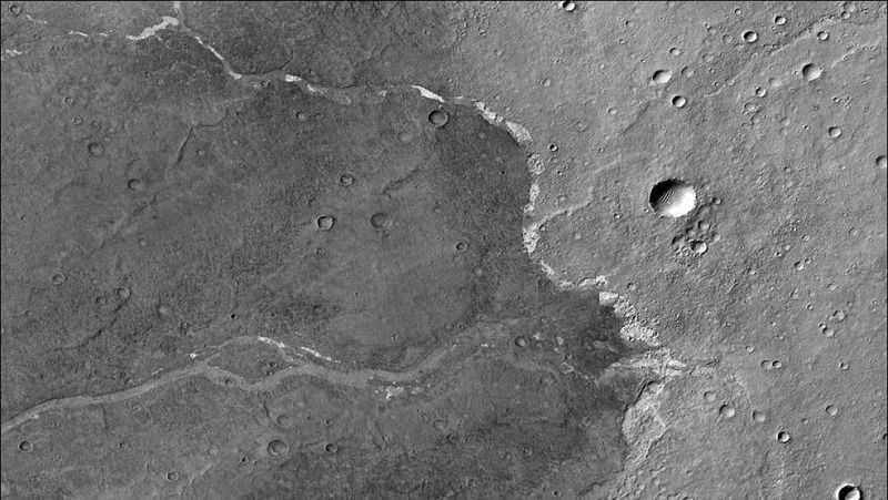 This image from NASA&#039;s Mars Reconnaissance Orbiter shows the Bosporos Planum plain on the Red Planet. The white specks are salt deposits found within a dry channel, a clue to its watery past.