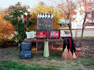 A market display of old household objects in an outside setting.