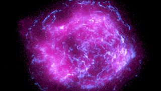 image of a supernova remnant showing glowing purple in the middle with ripples of blue energy throughout