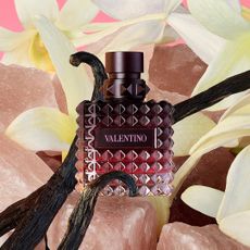 valentino bella dona intense perfume on a floral background