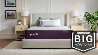 Purple Restore mattress in a bedroom, with a badge saying 'BIG SAVINGS'
