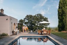 Pool house with dining table and decking