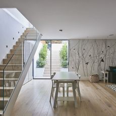 dining area with wooden flooring and wooden staircase