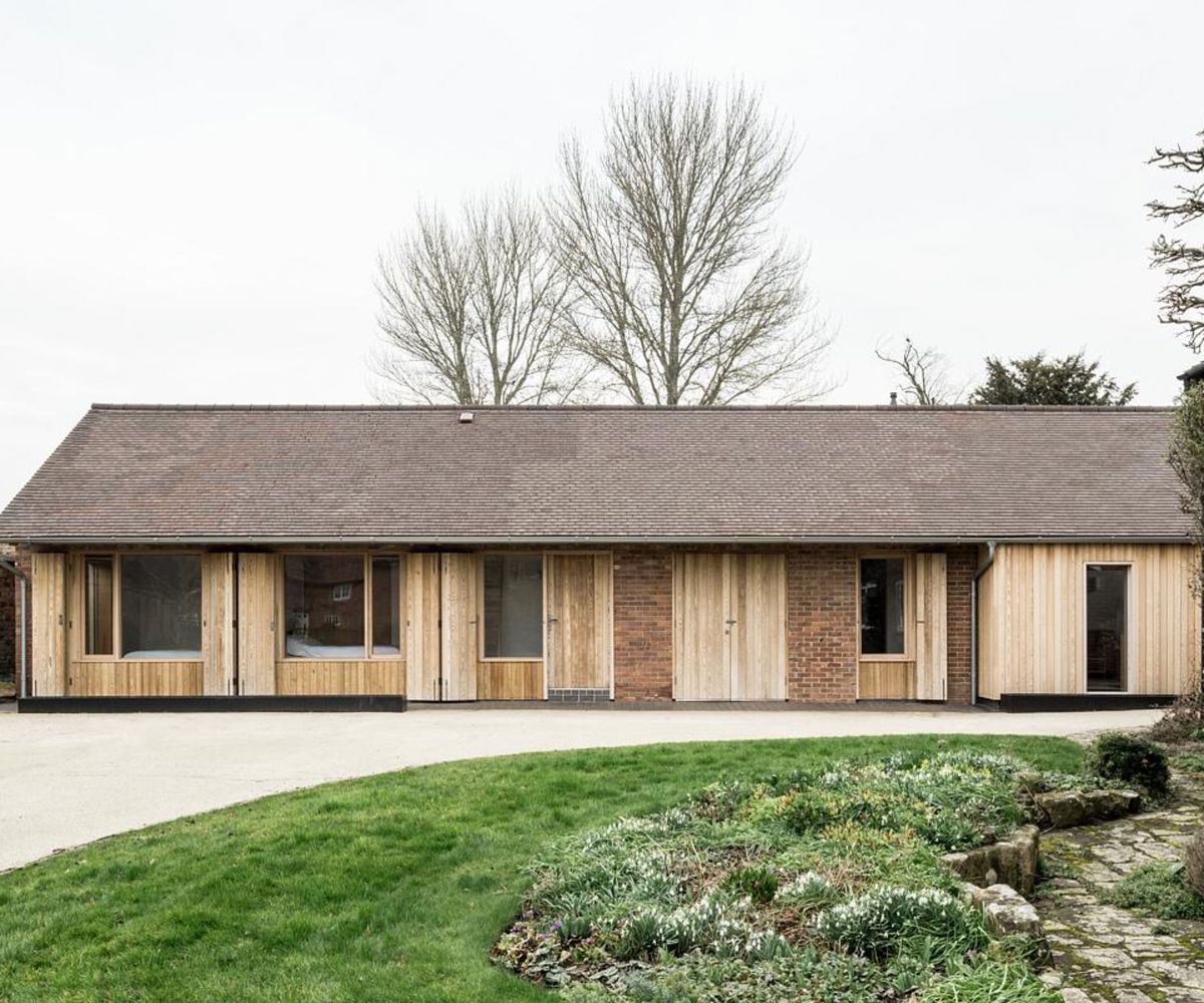 before and after images of garage block converted into an extended annexe with larch gladding and pitched roof