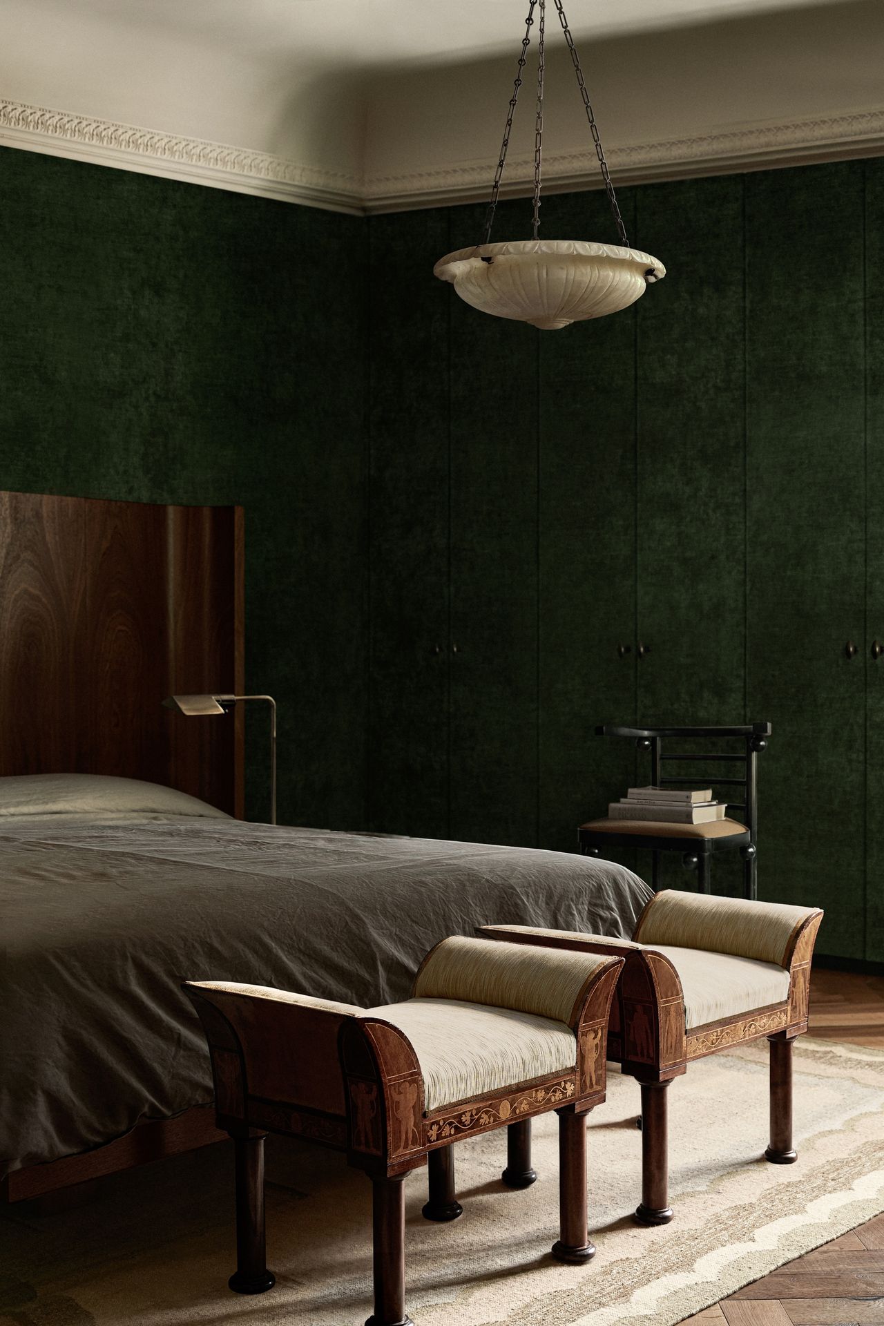 bedroom with green walls and grey bed spread