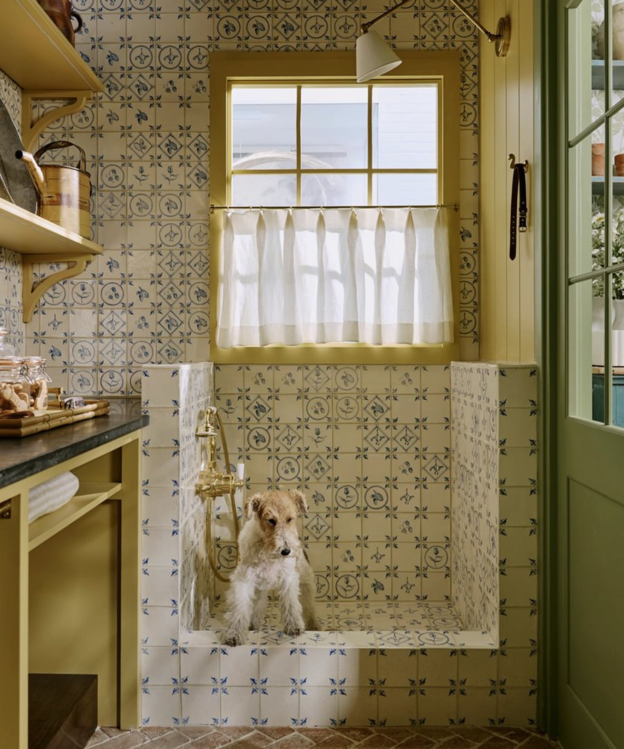 Sims Hilditch 'Dog Room' from 2025's WOW!house featuring a yellow boot room with a white and blue tiled dog shower