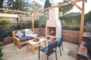 outdoor seating area with modern rendered fireplace