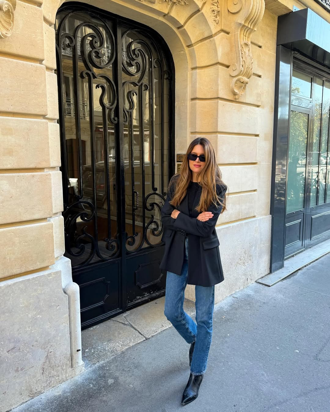 French woman wearing Western boots with jeans and black blazer.