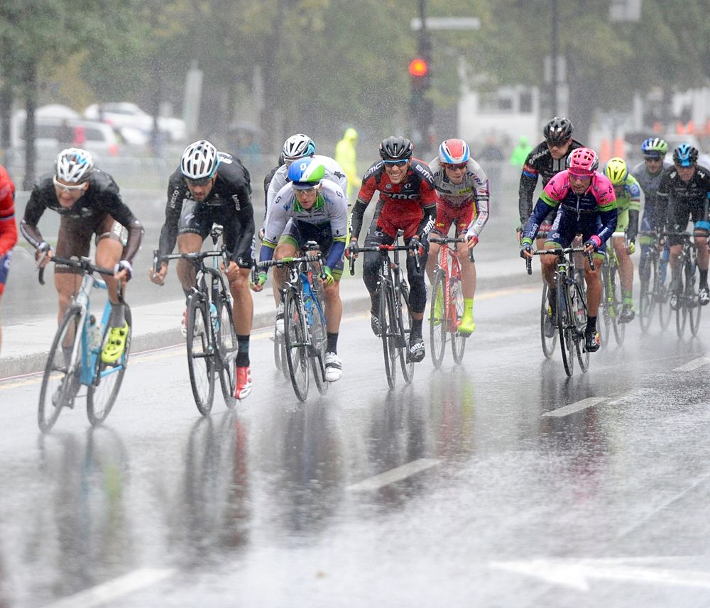 The peloton negotiating the slick roads through the pouring rain at the Grand Prix Cycliste de Montreal