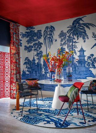 Blue and red dining room with blue and white wallpaper and red ceiling