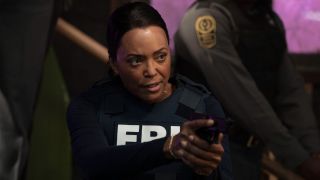 Tara aiming her gun on Criminal Minds: Evolution.